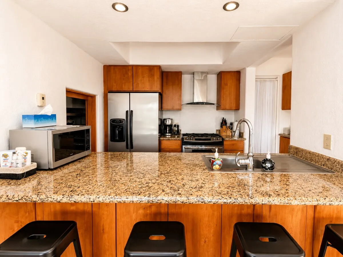 Kitchen with granite bar and stools